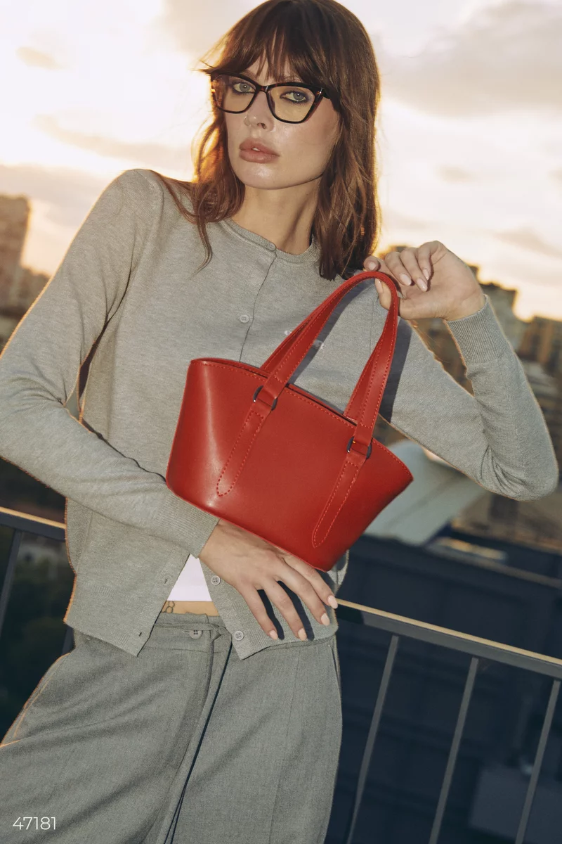 A red bag in the shape of a trapezoid photo 1