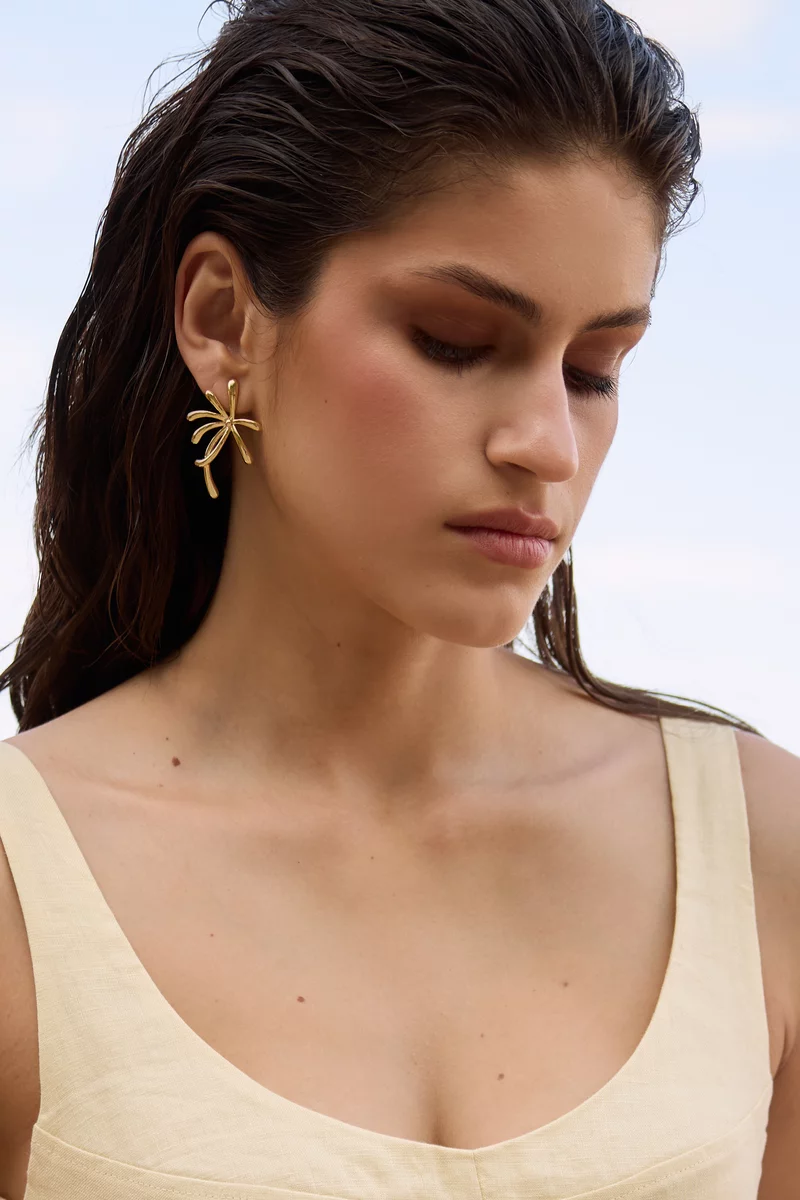 Gold earrings in the shape of a palm tree photo 1